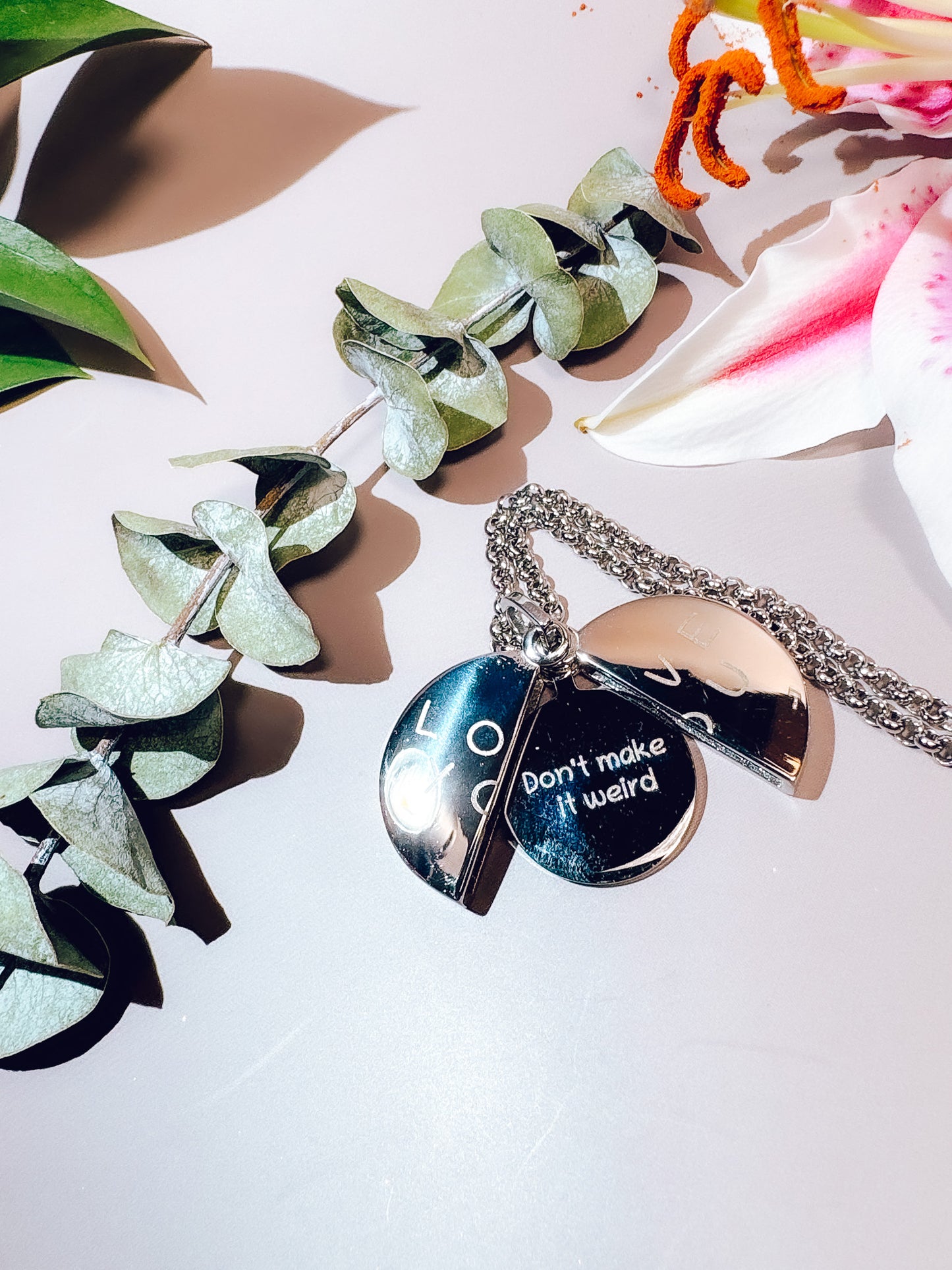 Necklace with heart-shaped pendant on a light background with decorative elements