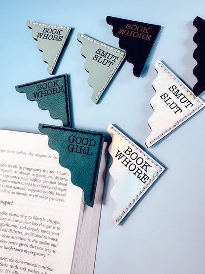 Bookmarks with humorous text on a book against a light blue background