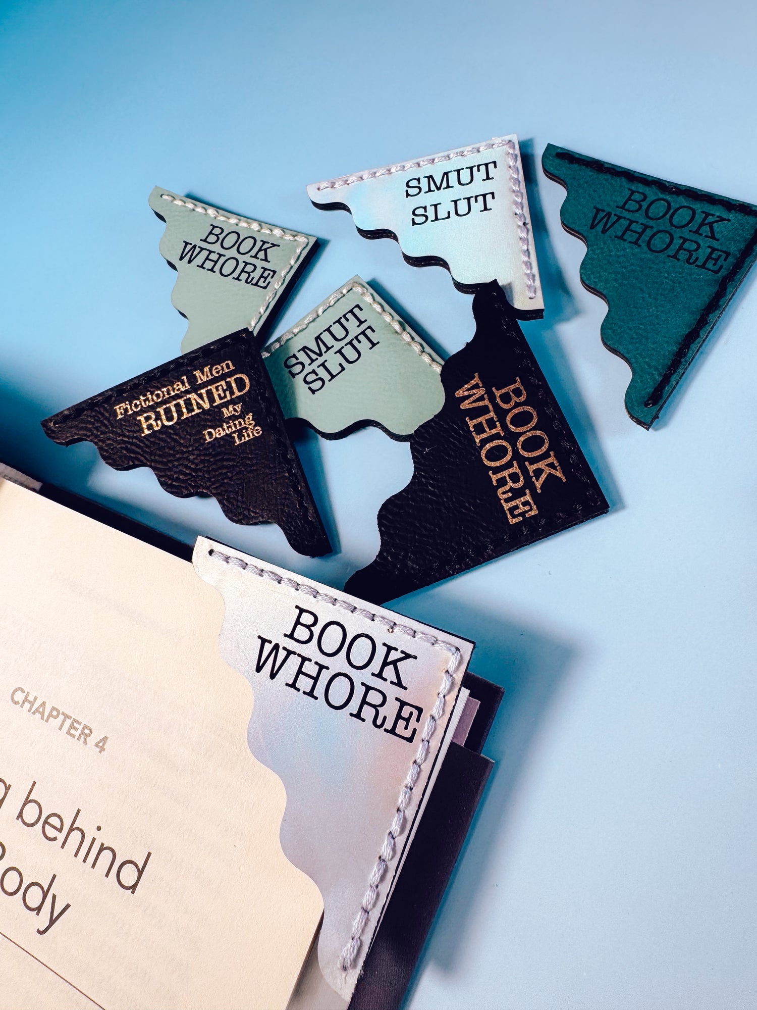Bookmarks with humorous text on a book against a light blue background