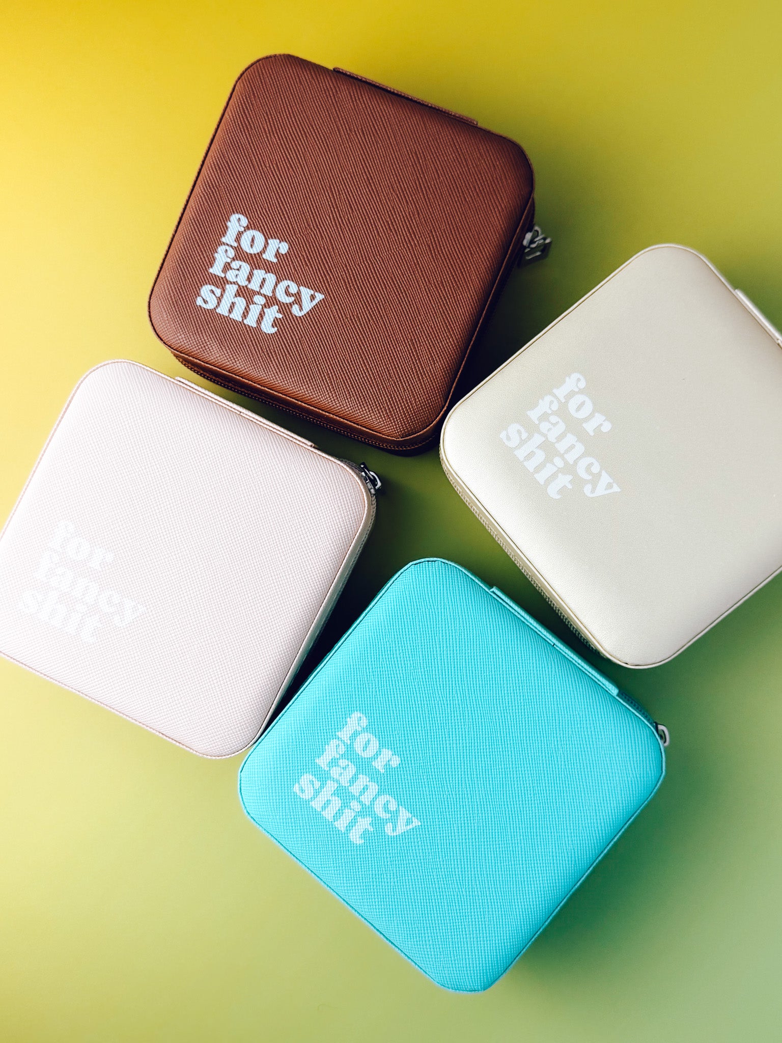 Four small rectangular cases in different colors with text on a gradient background