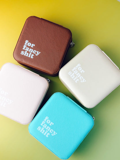 Four small rectangular pouches with text on a gradient yellow to green background