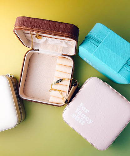 Jewelry case with gold rings on a green background